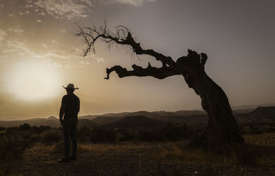 Silhouette of adult man standing on desert during sunset. almeria, spain