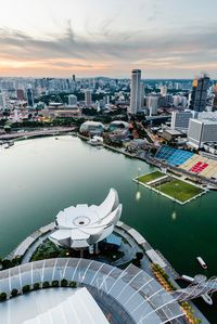 High angle view of swimming pool by buildings against sky