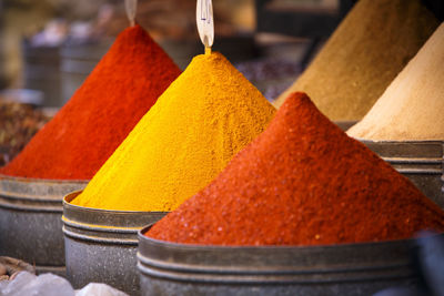 Close-up of various spices in container for sale at market stall