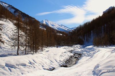 Scenic view of snow covered mountains against sky