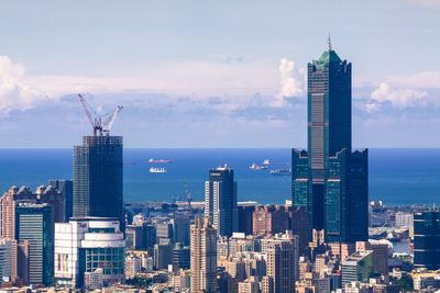 Modern buildings in city against sky