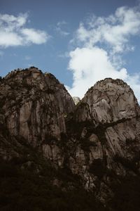 Low angle view of rock formations against sky