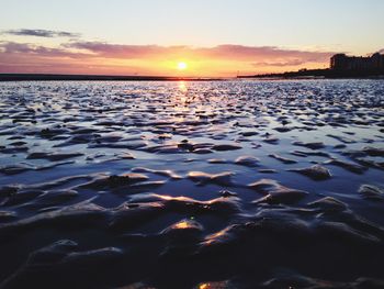 Scenic view of lake at sunset