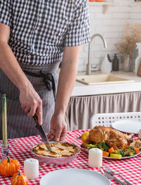 Midsection of man preparing food in kitchen