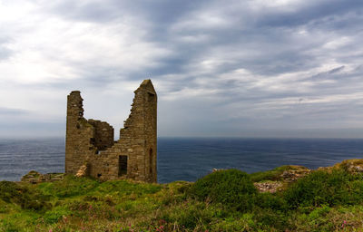 Historic building by sea against sky
