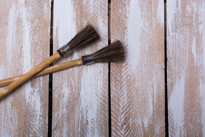 Close-up of paintbrushes on wooden wall