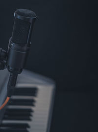 Close-up of piano keys against black background