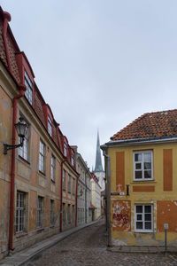 Low angle view of buildings in town against sky