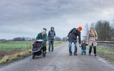 Family on road against sky