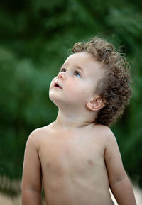 Cute baby boy looking away outdoors