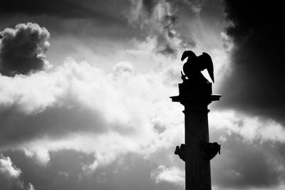 Low angle view of statue against cloudy sky