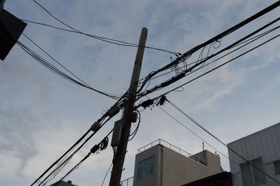 Low angle view of electricity pylon against sky