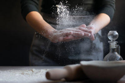 Woman baker with flour in her hands