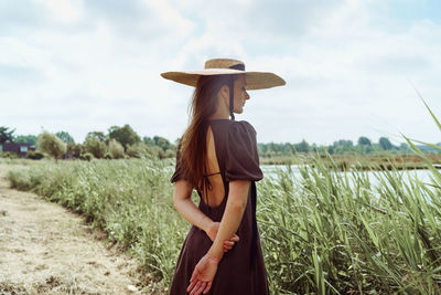 Rear view of woman standing on field