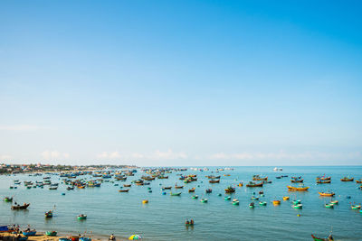 High angle view of boats in sea against clear sky