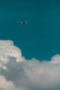 Low angle view of airplane flying in sky