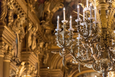 Low angle view of illuminated chandelier in building