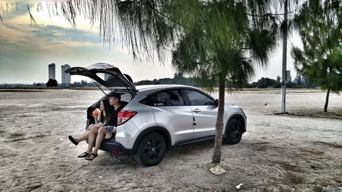 Motorcycle on beach against sky