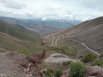 Serpentine road between the mountains towards the sky