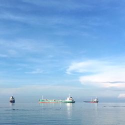 Boats in sea against sky