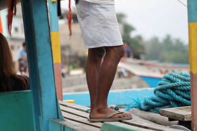 Close-up of woman standing on railing