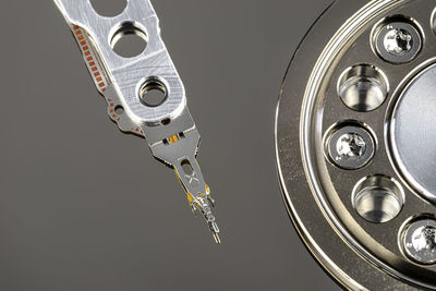 Macro shot of a magnetic needle on a hard disk platter, open hdd disk, perfectly clean surface.