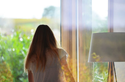 Rear view of woman in glass window