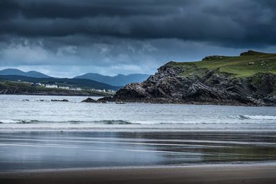 Scenic view of sea against cloudy sky