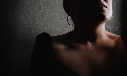 Portrait of young woman against wall