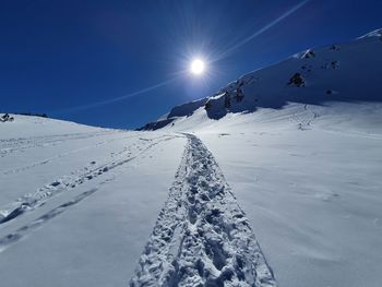 Snow covered mountain against blue sky