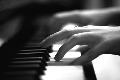 Close-up of hands playing piano