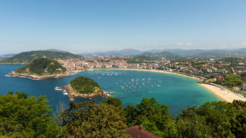 High angle view of sea and cityscape against sky