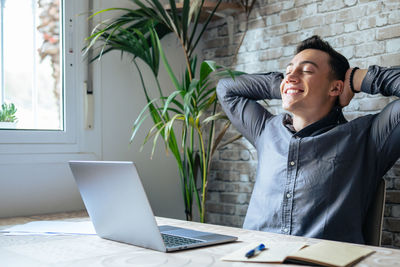 Portrait of young businesswoman working on table