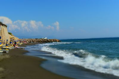 Scenic view of beach against blue sky