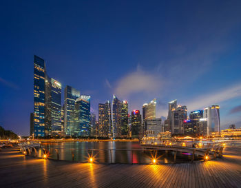 Illuminated buildings against sky at night