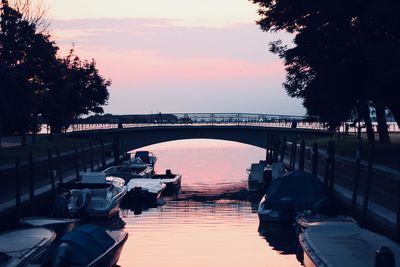 Bridge over river against sky during sunset