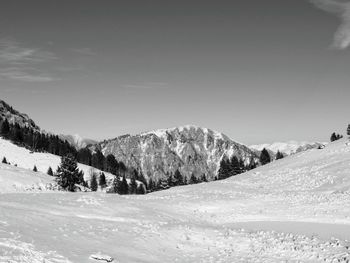 Scenic view of snow covered mountains against sky