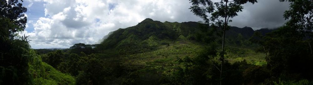 Scenic view of mountains against cloudy sky