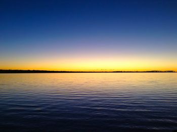 Scenic view of sea against clear sky during sunset