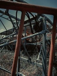 Close-up of rusty metallic structure on field