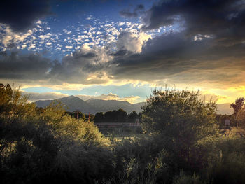 Scenic view of mountains against cloudy sky