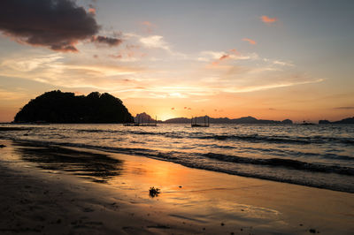 Scenic view of beach against sky during sunset