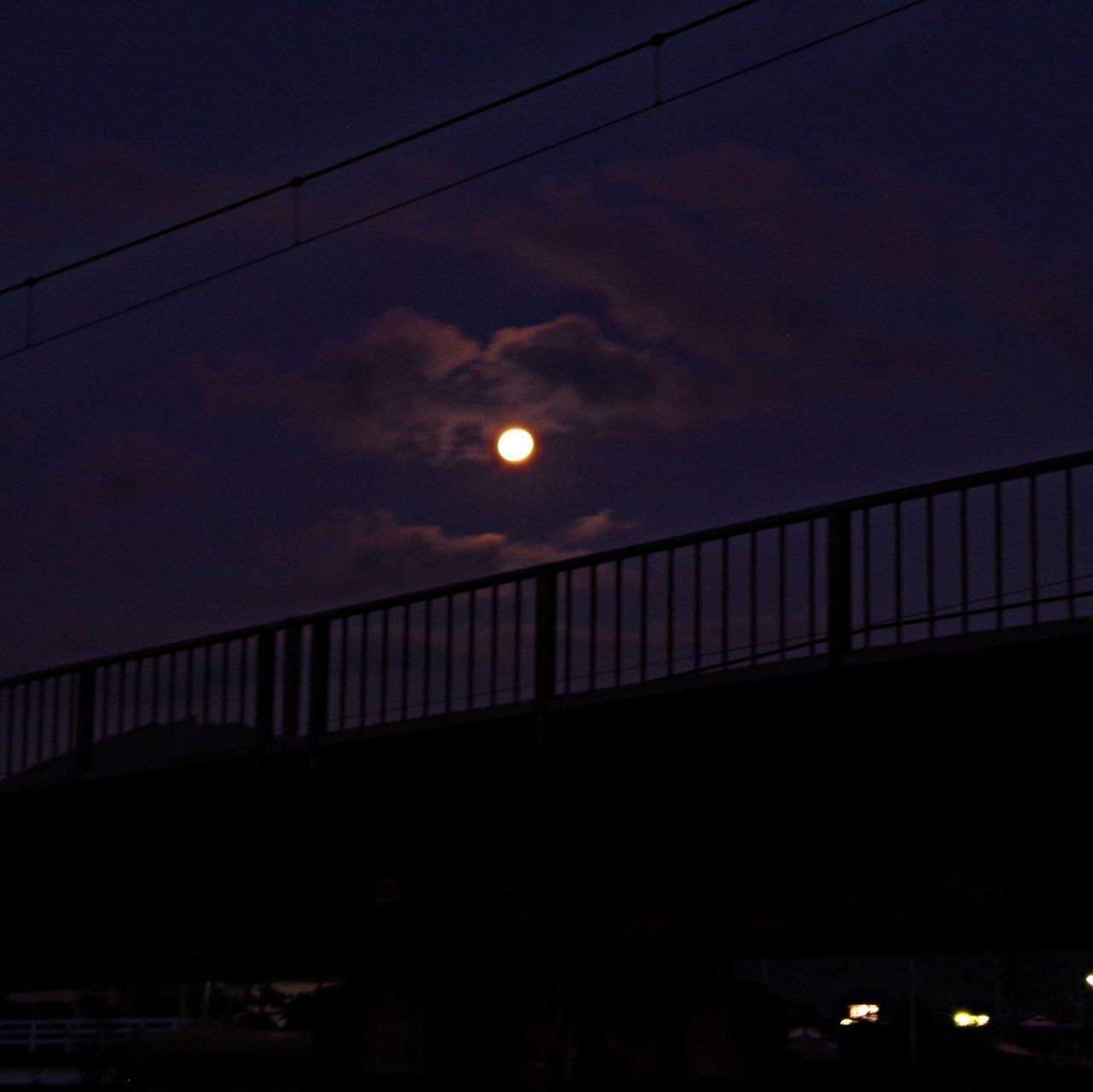 sky, connection, built structure, cable, illuminated, silhouette, power line, low angle view, architecture, street light, bridge - man made structure, cloud - sky, dusk, night, electricity, sunset, lighting equipment, dark, moon, bridge