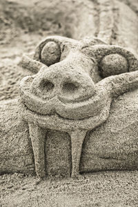 Close-up of angel statue on sand