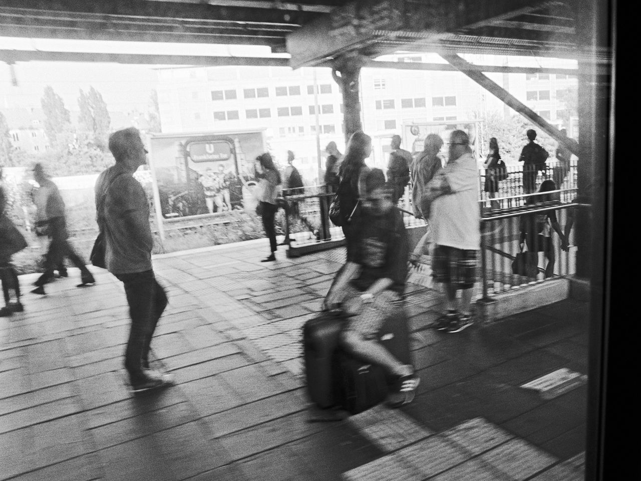 GROUP OF PEOPLE WALKING IN CORRIDOR