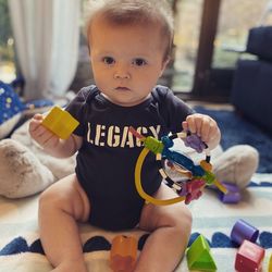 Portrait of cute boy with toy sitting at home