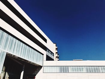 Low angle view of building against clear blue sky