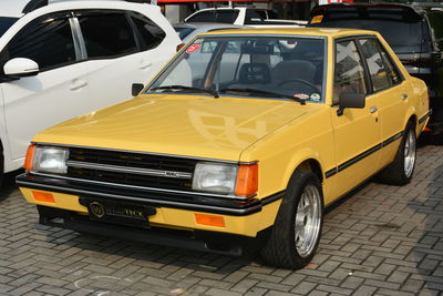 View of yellow car on street