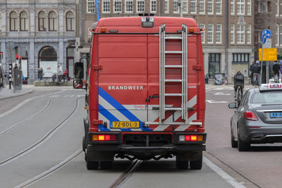 Cars on road against buildings in city