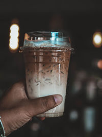 Close-up of hand holding drink